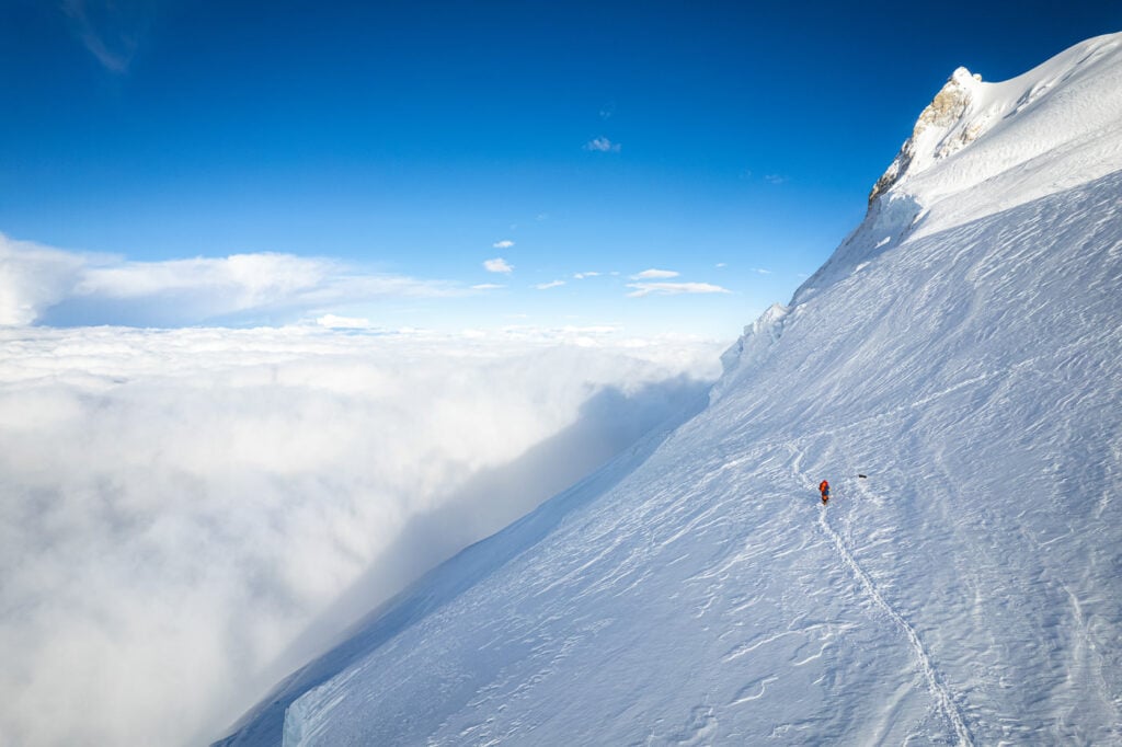 a person skiing down a snowy mountain side