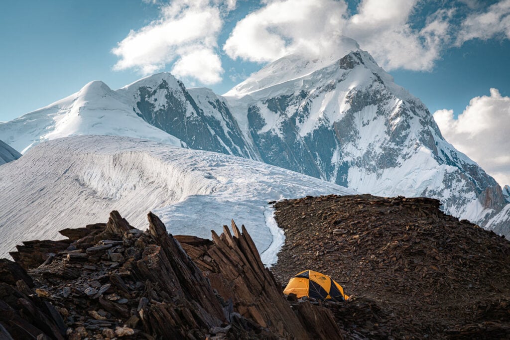 a tent pitched up on top of a mountain